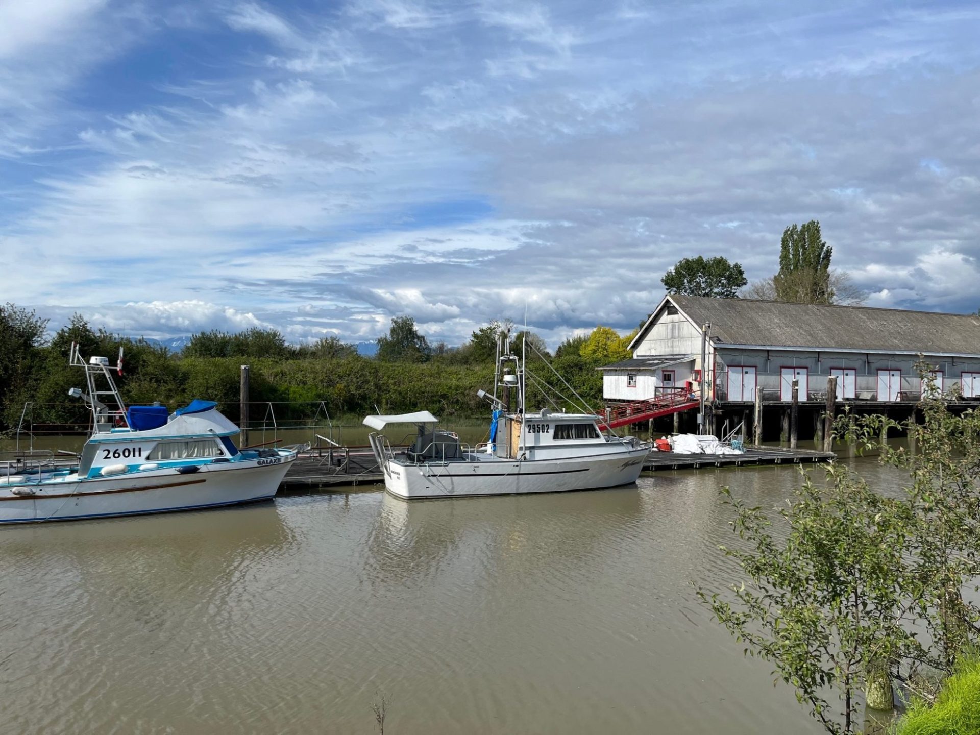 Fish boats moored beside the wooden building at Scotch Pond